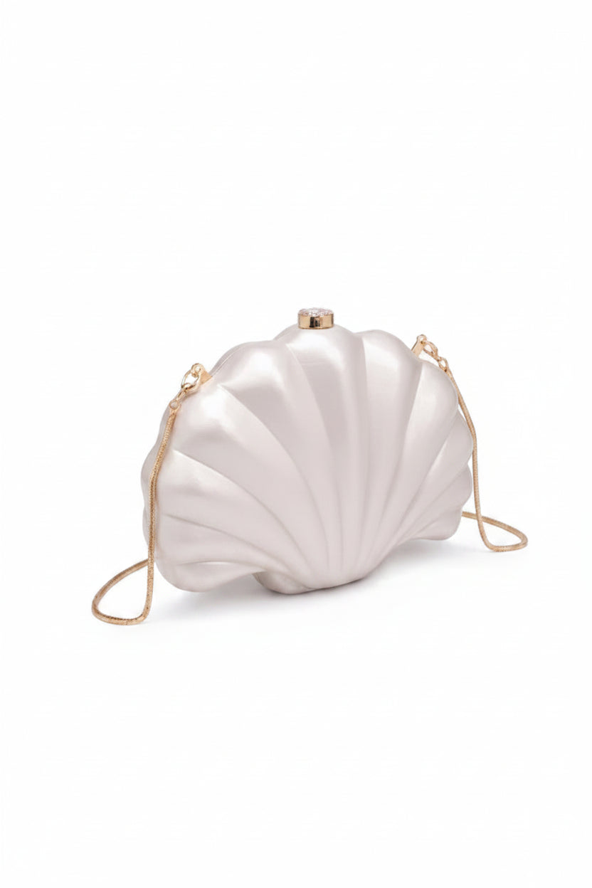 Shell-shaped handbag with a gold chain on a white background