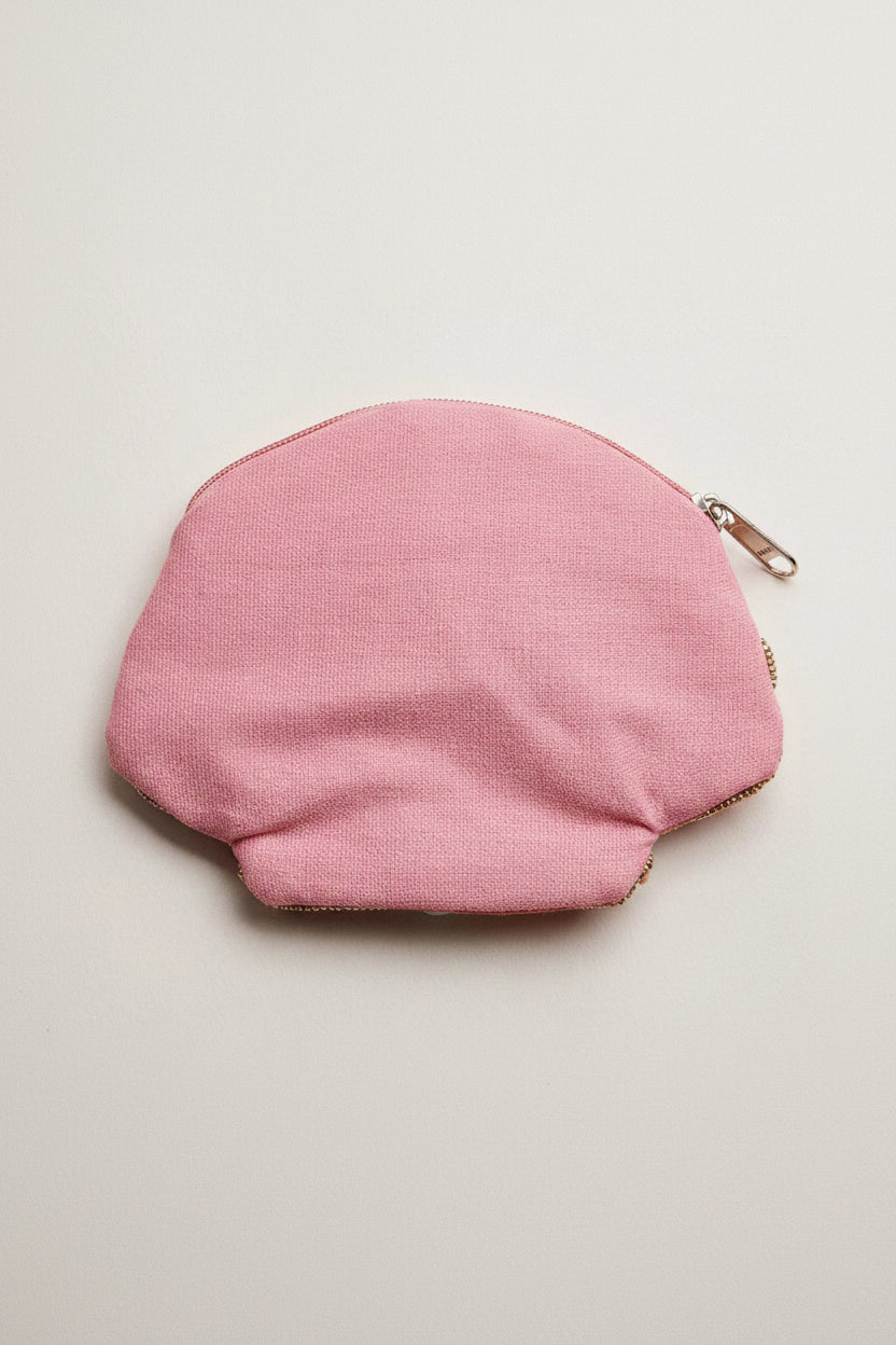Pink fabric pouch with a gold zipper on a light gray background