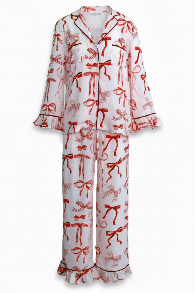 White pajama set with red bow pattern on a white background