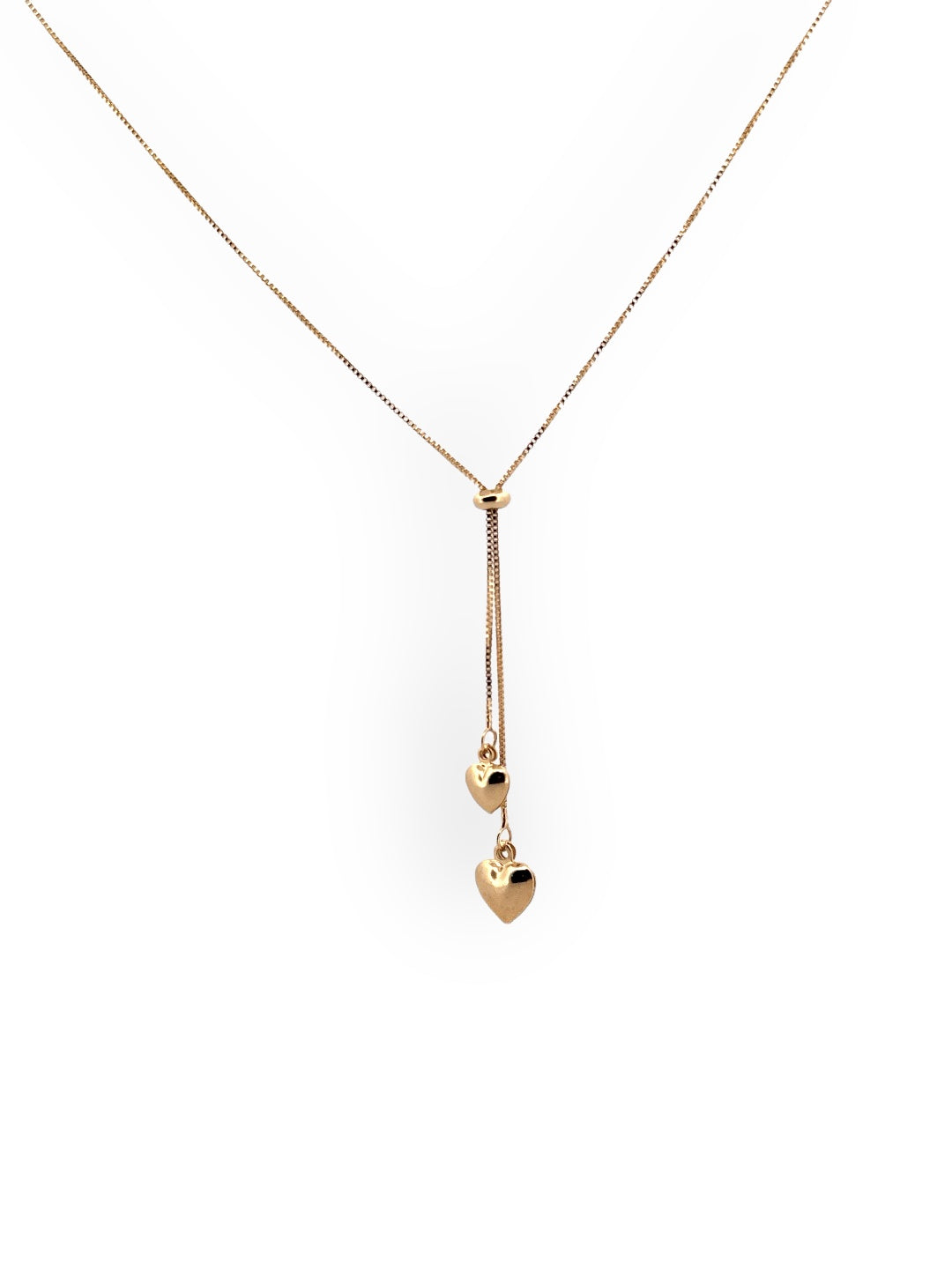 A gold lariat necklace with two heart charms, one larger than the other, on a white background. Lariat