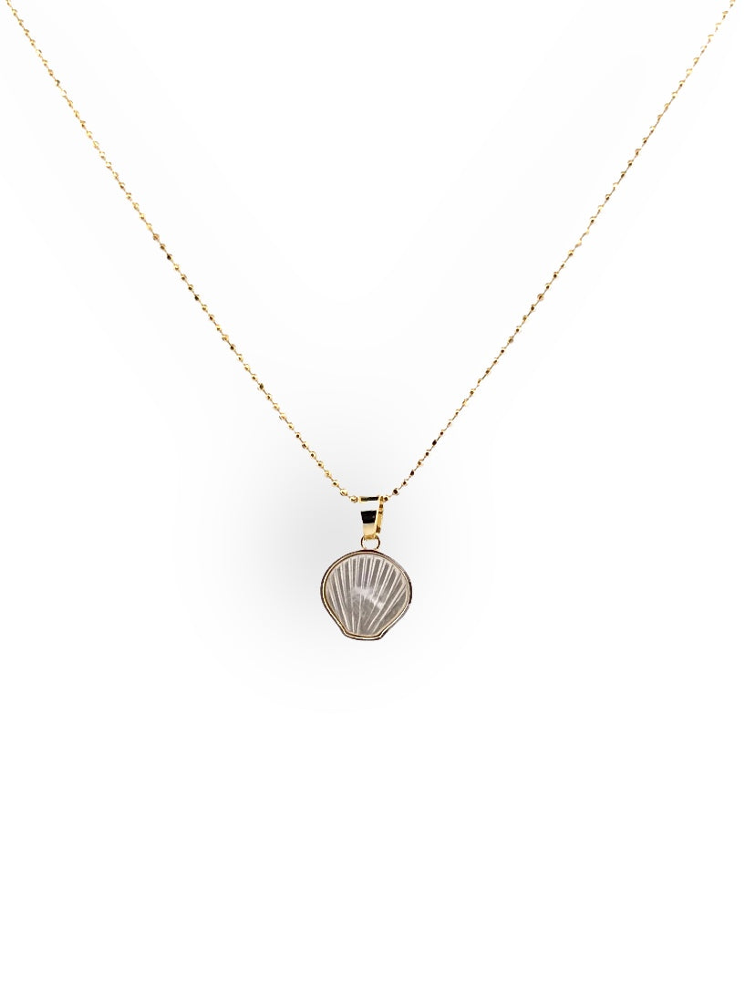 Layered beach-inspired necklaces with tiny gold shell