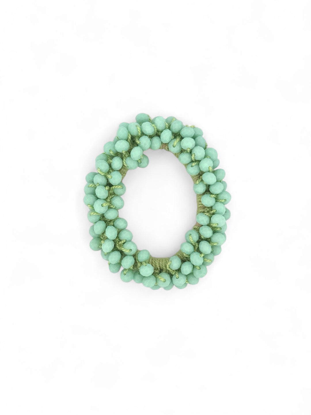 Handmade pearl beaded hair tie on white background