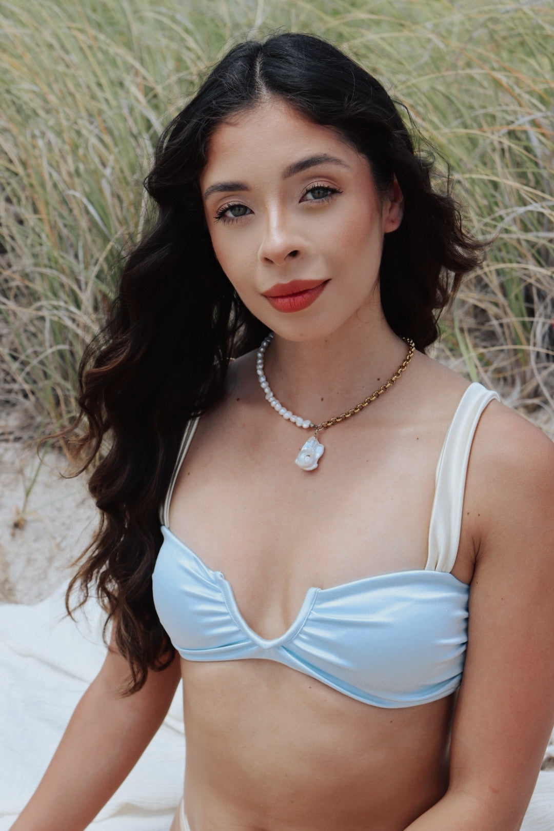 Woman wearing the Half and Half Pearl & Chain Pendant Necklace, showcasing the asymmetrical design with freshwater pearls and gold chain