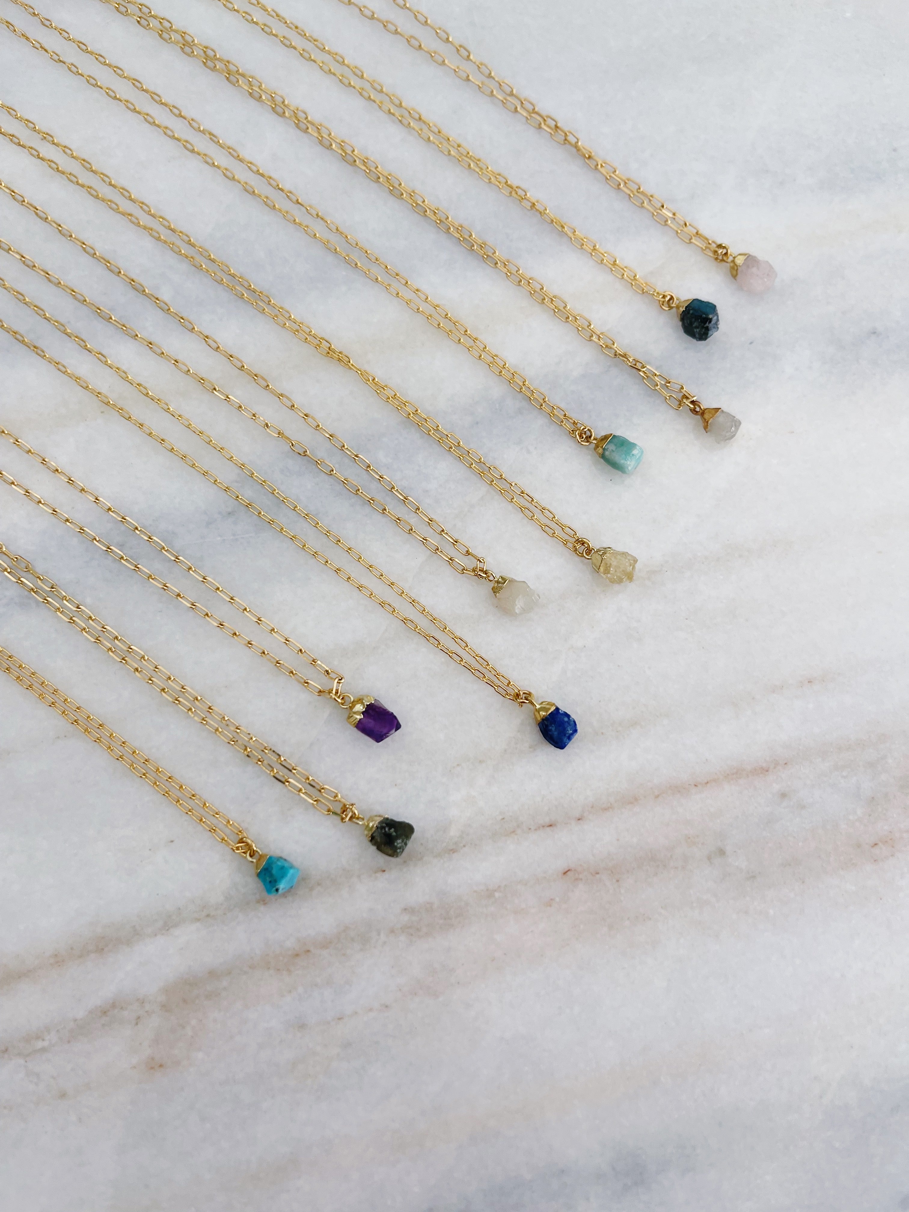 Close-up of the Mini Crystal Irregular Charm Necklace with natural stone charm and dainty gold chain by Carolina Benoit