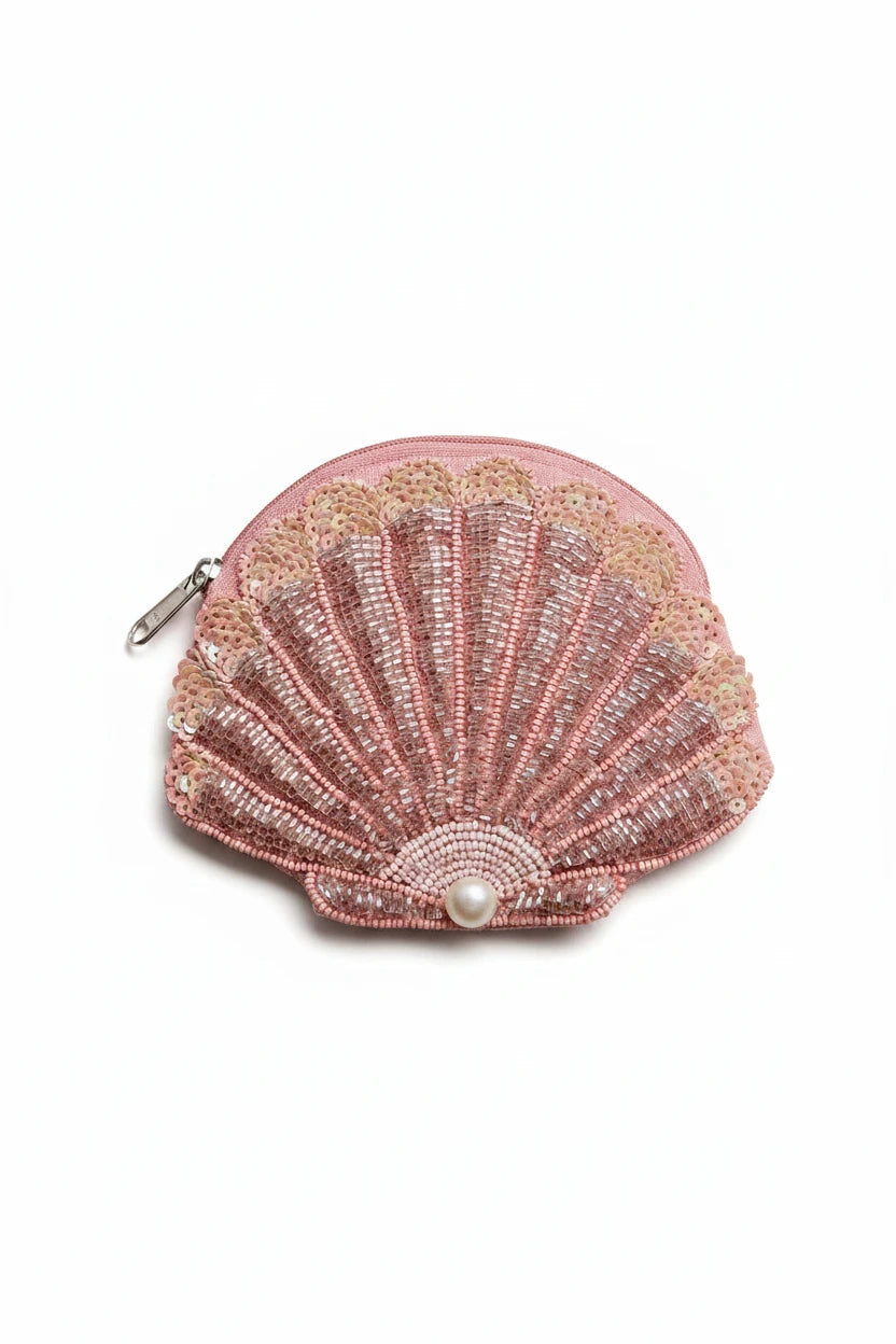 Pink shell-shaped beaded purse with a pearl on a light background
