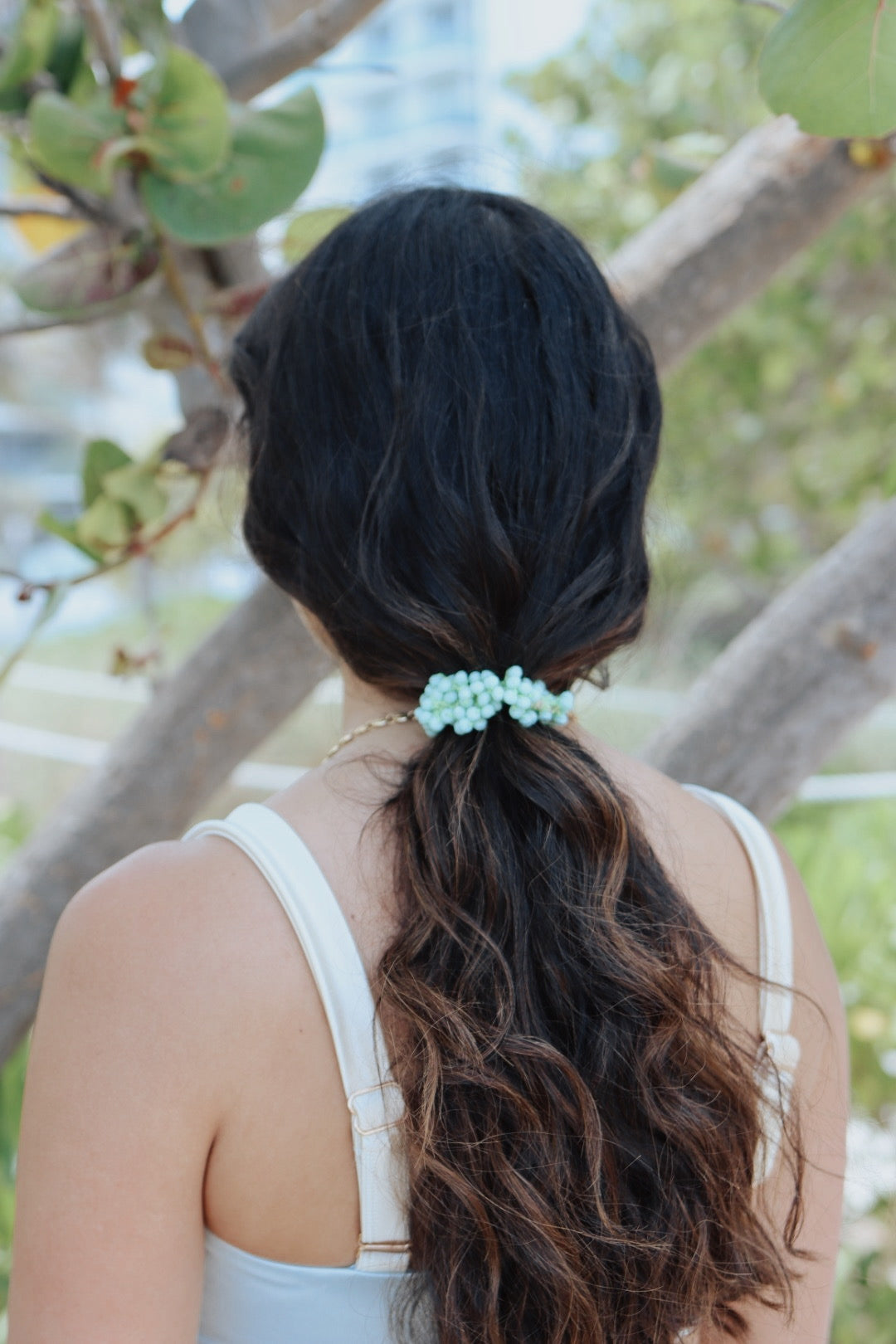 Handmade pearl beaded hair tie on white backgroun