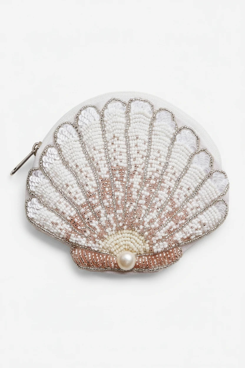 Shell-shaped pouch with beading and a pearl on a light background
