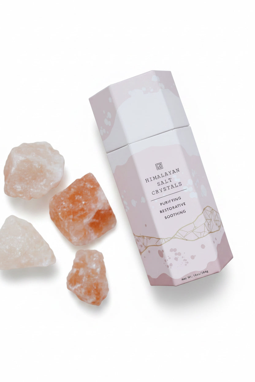 Himalayan salt crystals with a pink packaging on a light background