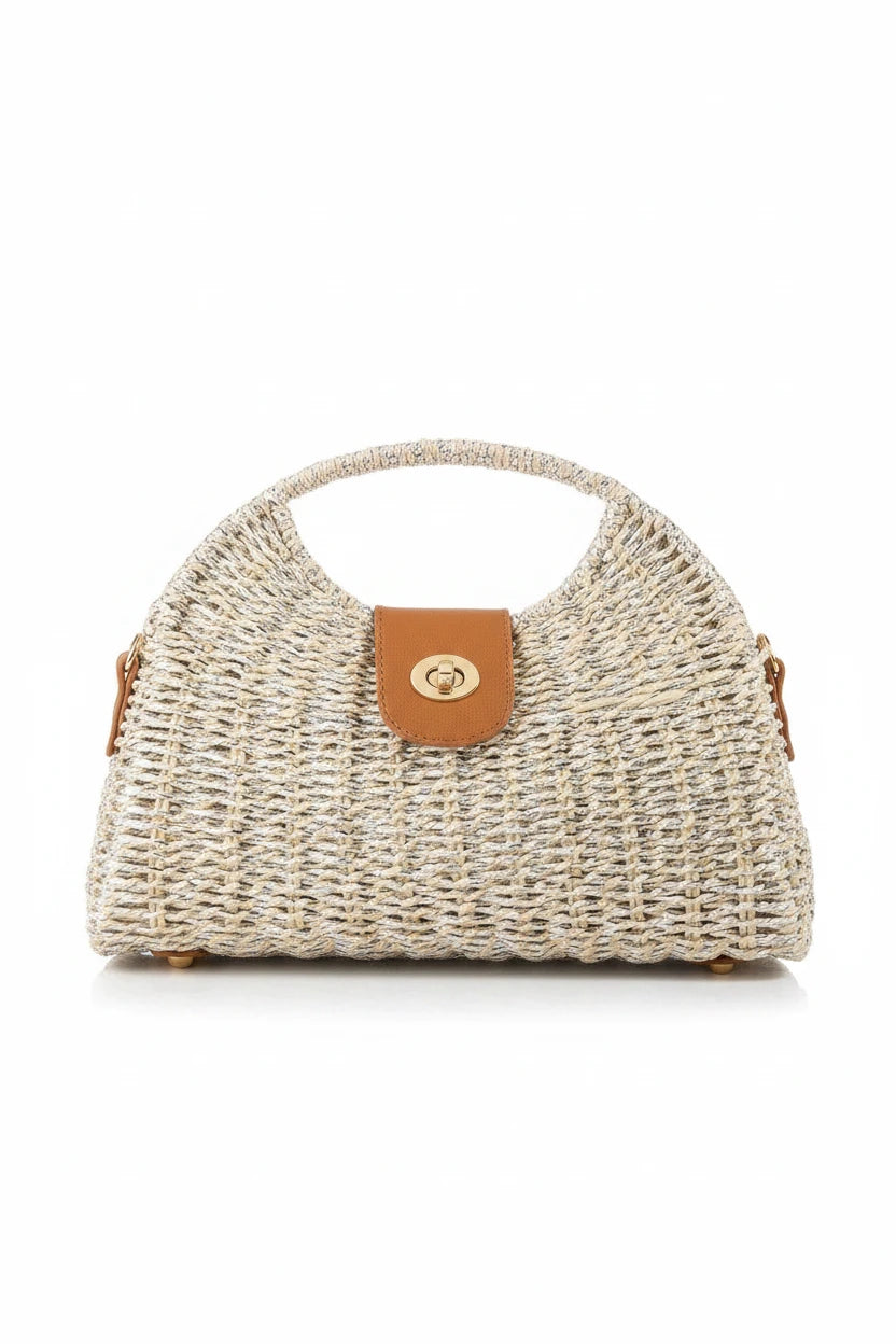 Woven handbag with a brown leather patch on a wooden surface