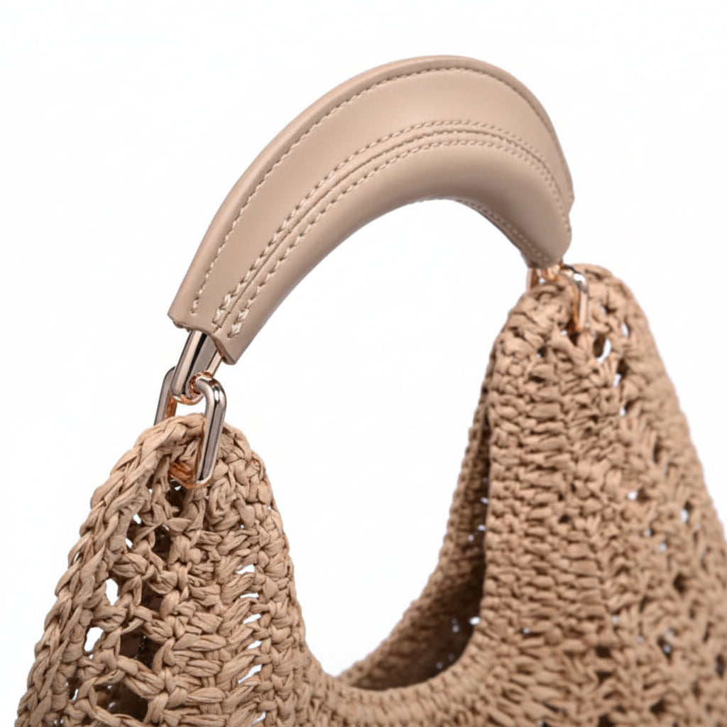 Close-up of a beige woven handbag with a leather handle on a white background