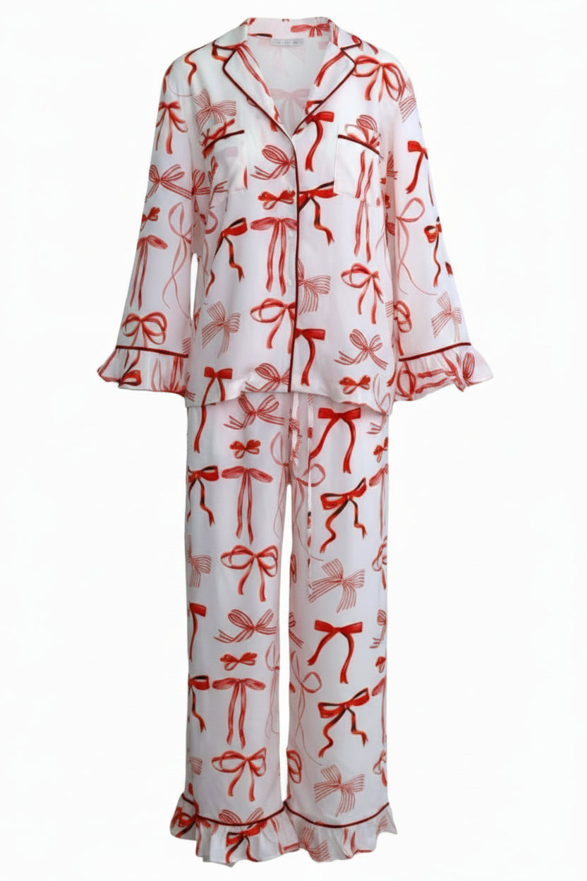 White pajama set with red bow pattern on a white background