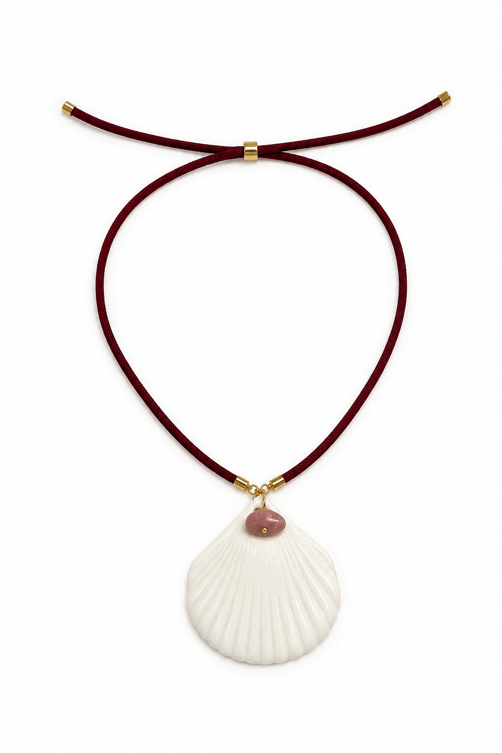 A necklace featuring a large white seashell pendant with a small pink stone accent, suspended from a dark red cord with gold-toned hardware, set against a plain white background.