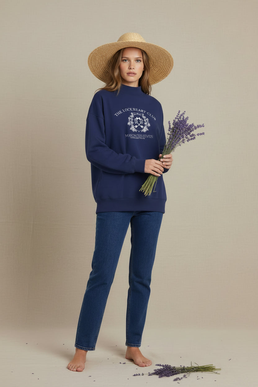 Woman wearing a navy blue sweatshirt with a logo on a white background