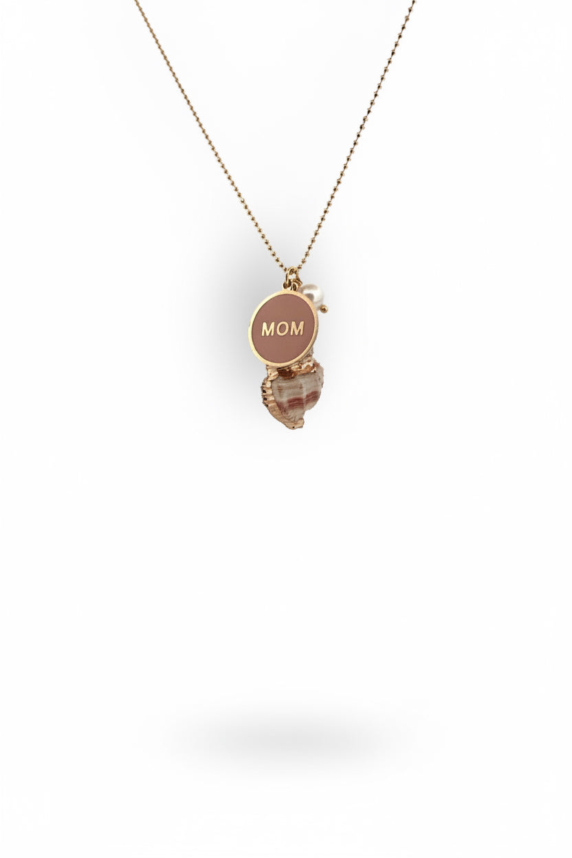 A gold necklace with a natural seashell pendant painted with gold, a freshwater pearl, and a gold coin metal charm.