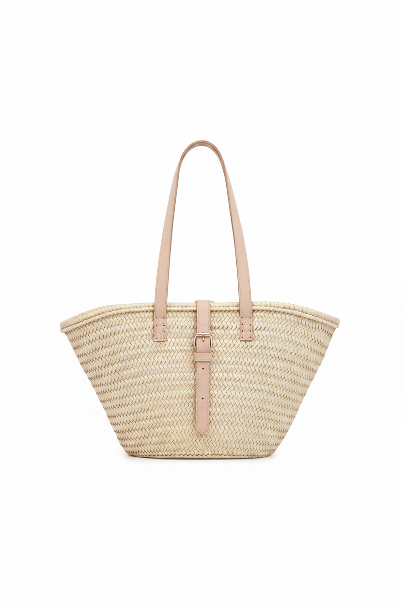 Beige straw tote bag with a matching strap on a white background