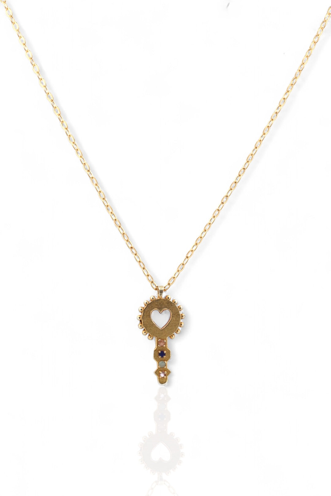 Gold necklace with a heart pendant on a white background