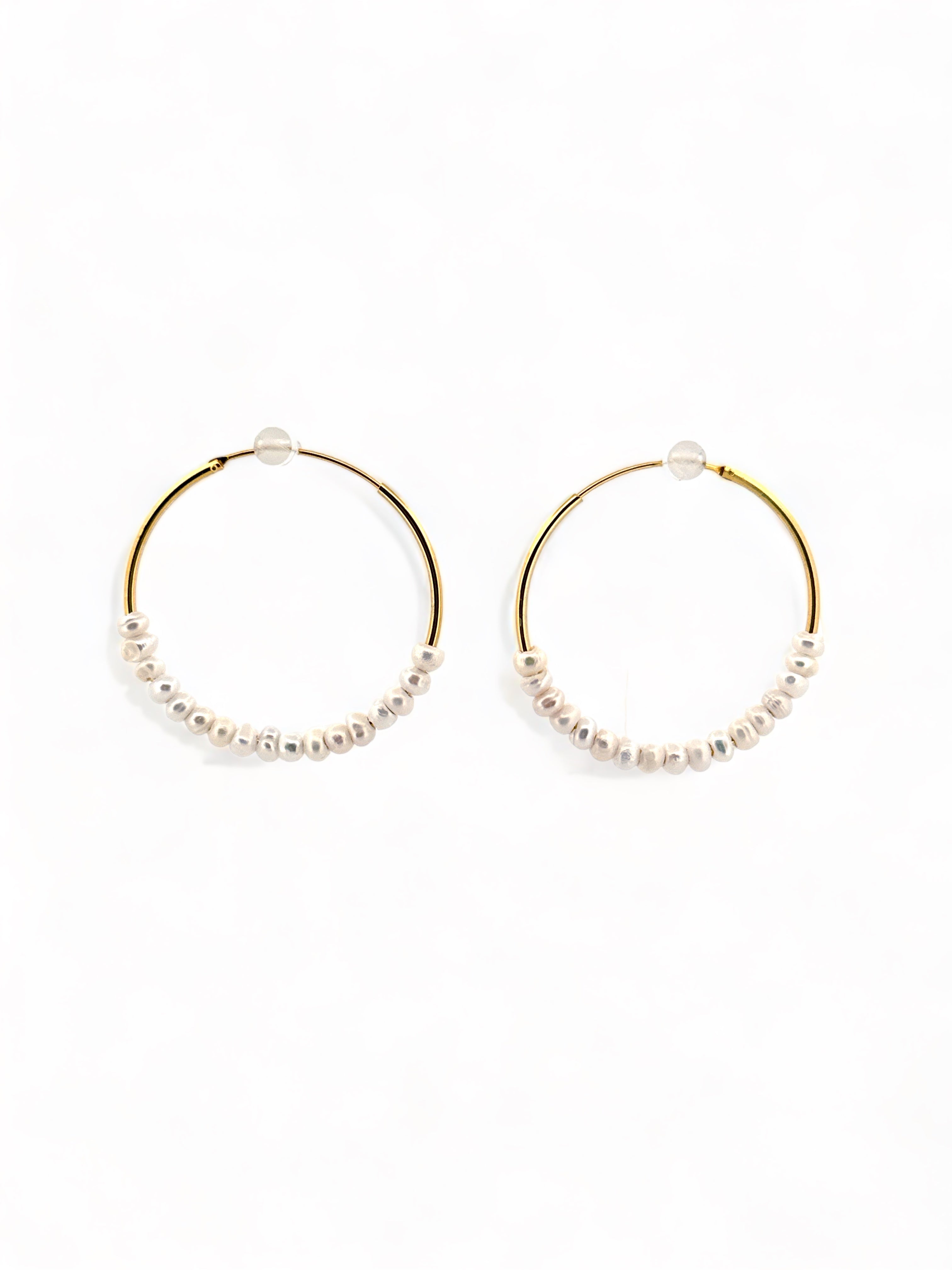 A pair of gold-plated hoop earrings adorned with natural fresh water pearls