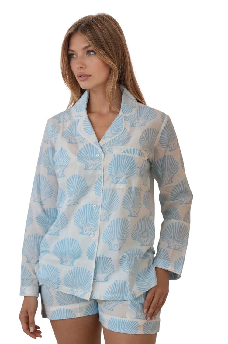Women’s cotton pajama set with blue seashell print, long sleeve button-down top and matching shorts.